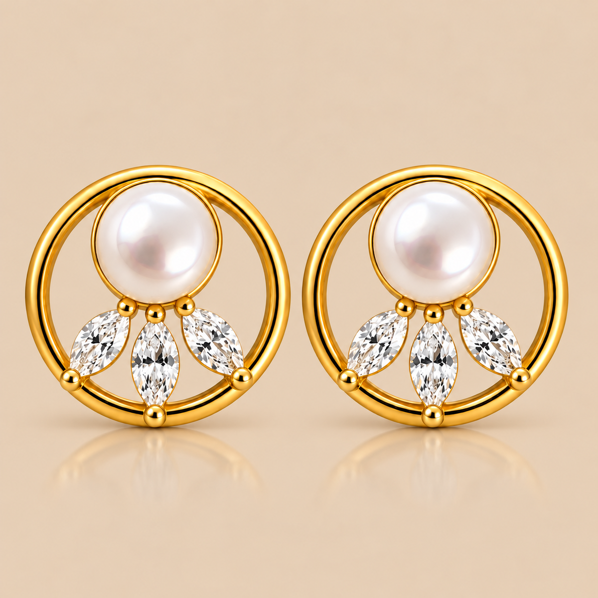 A pair of gold-plated stud earrings featuring a white freshwater pearl and three marquise-cut clear crystals, set against a warm beige background.