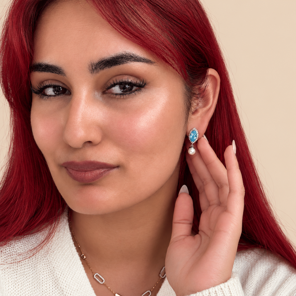 Drop earrings featuring marquise-cut swiss blue topaz surrounded by small white pearls and silver-toned beads, with round white pearl drops below