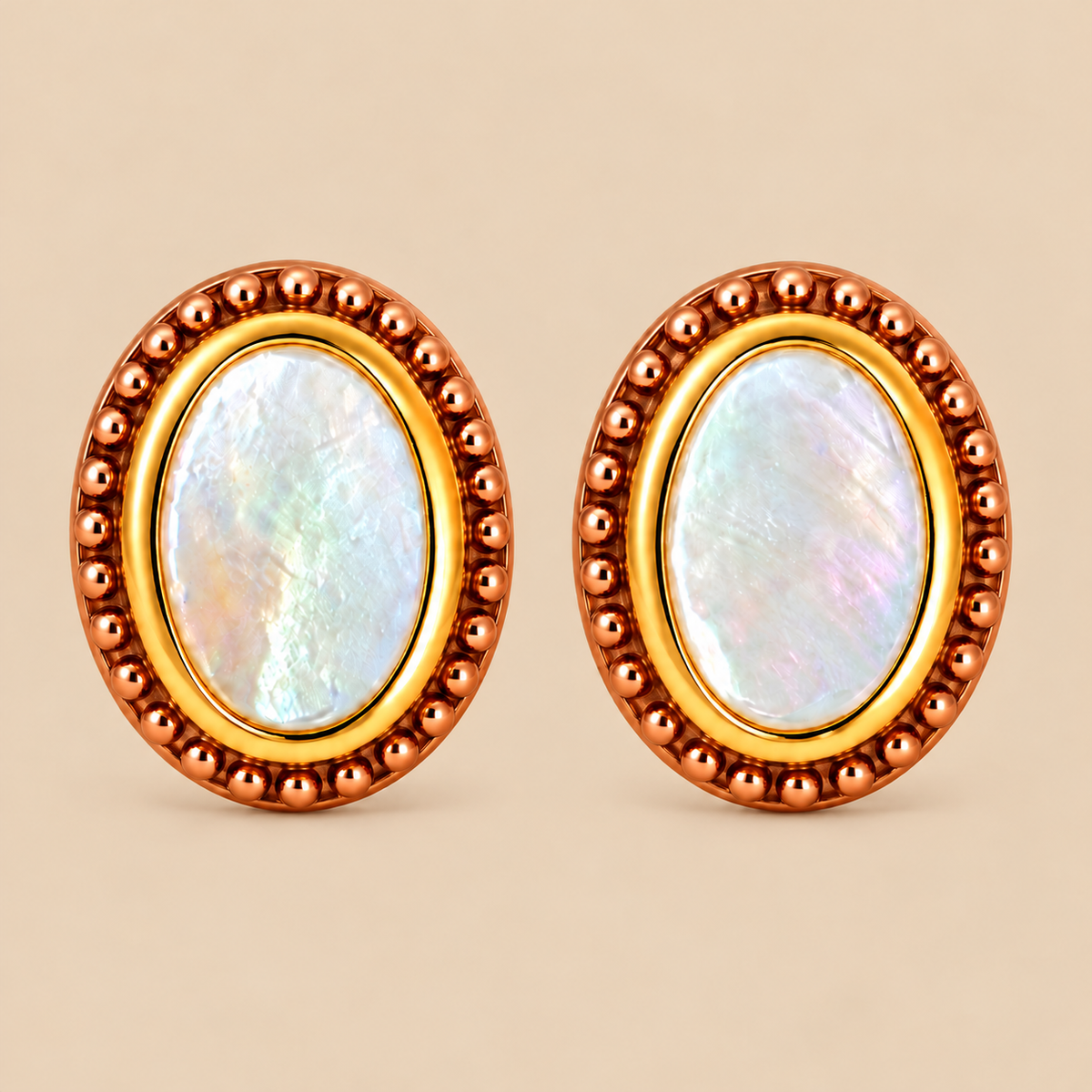 A pair of oval stud earrings with iridescent mother-of-pearl centers, surrounded by a gold inner ring and a textured rose gold plated outer bezel, set against a solid beige background.