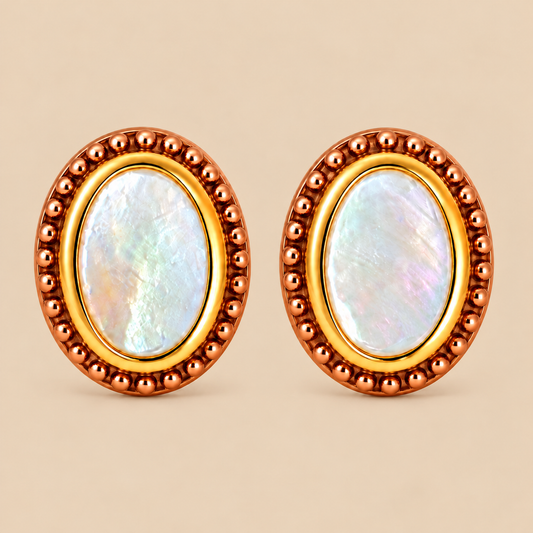 A pair of oval stud earrings with iridescent mother-of-pearl centers, surrounded by a gold inner ring and a textured rose gold plated outer bezel, set against a solid beige background.