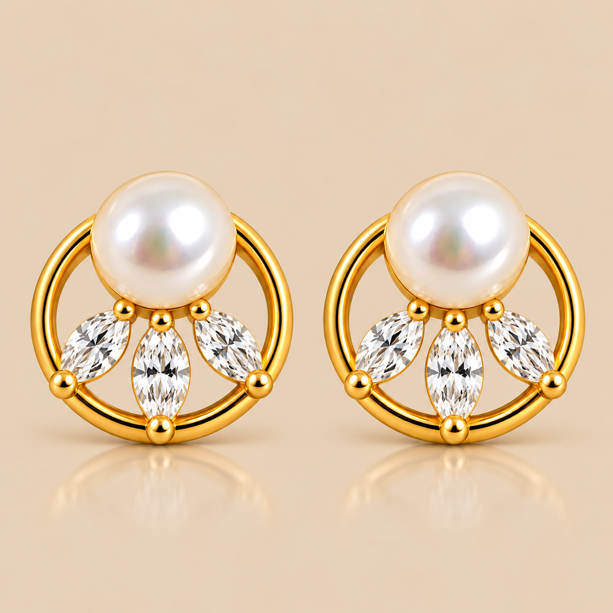 A pair of gold-plated stud earrings featuring a white freshwater pearl and three marquise-cut clear crystals, set against a warm beige background.